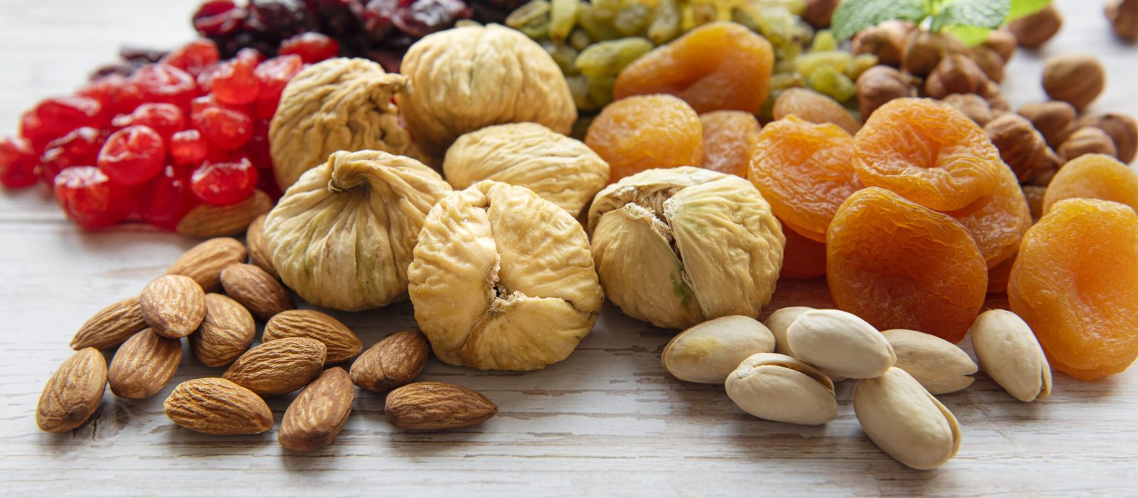 Various dried fruits and nuts on a wooden  background
